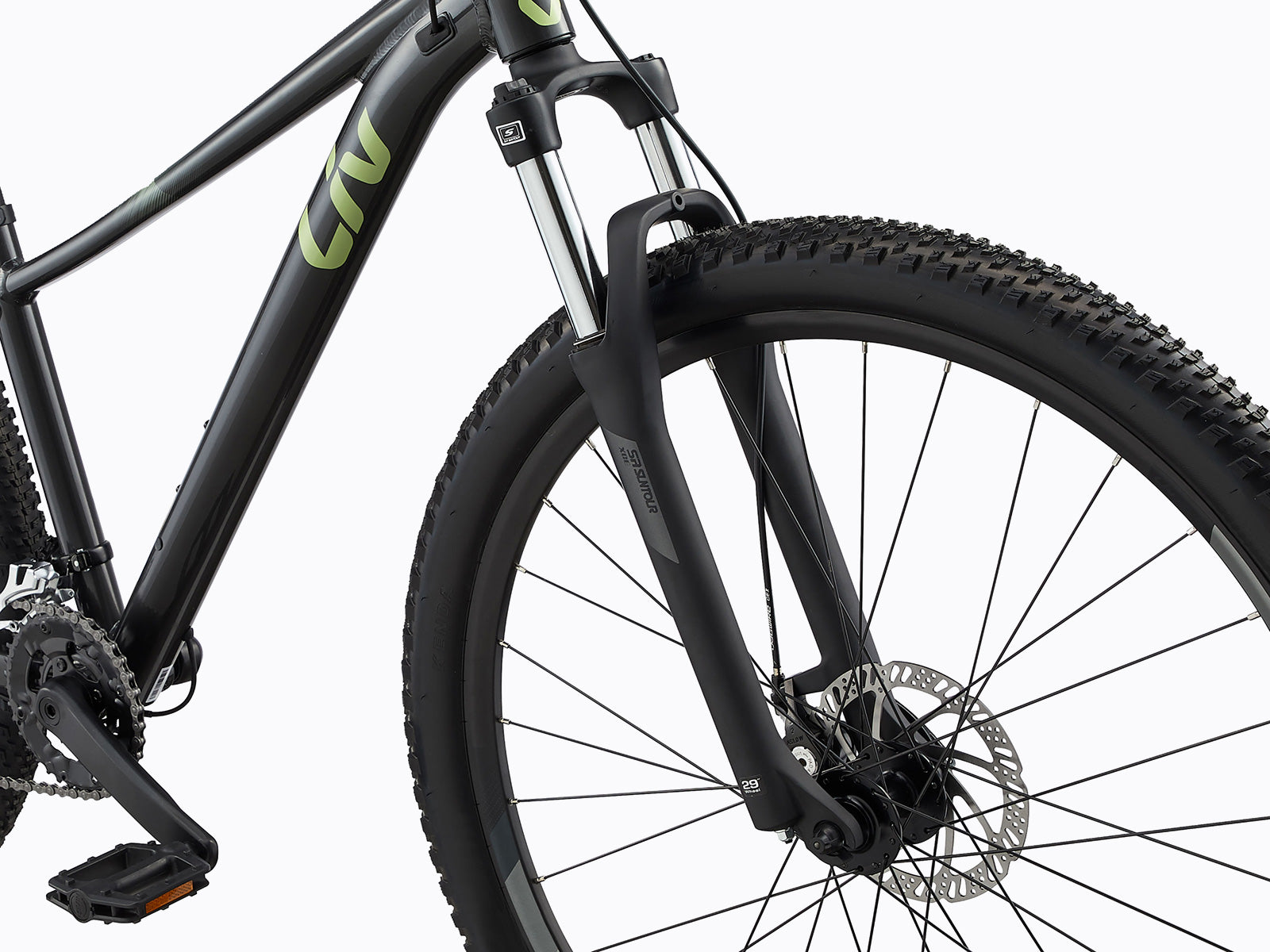 A mountain bike featuring a detailed view of its front wheel and tire, emphasizing the rugged tread for off-road performance.