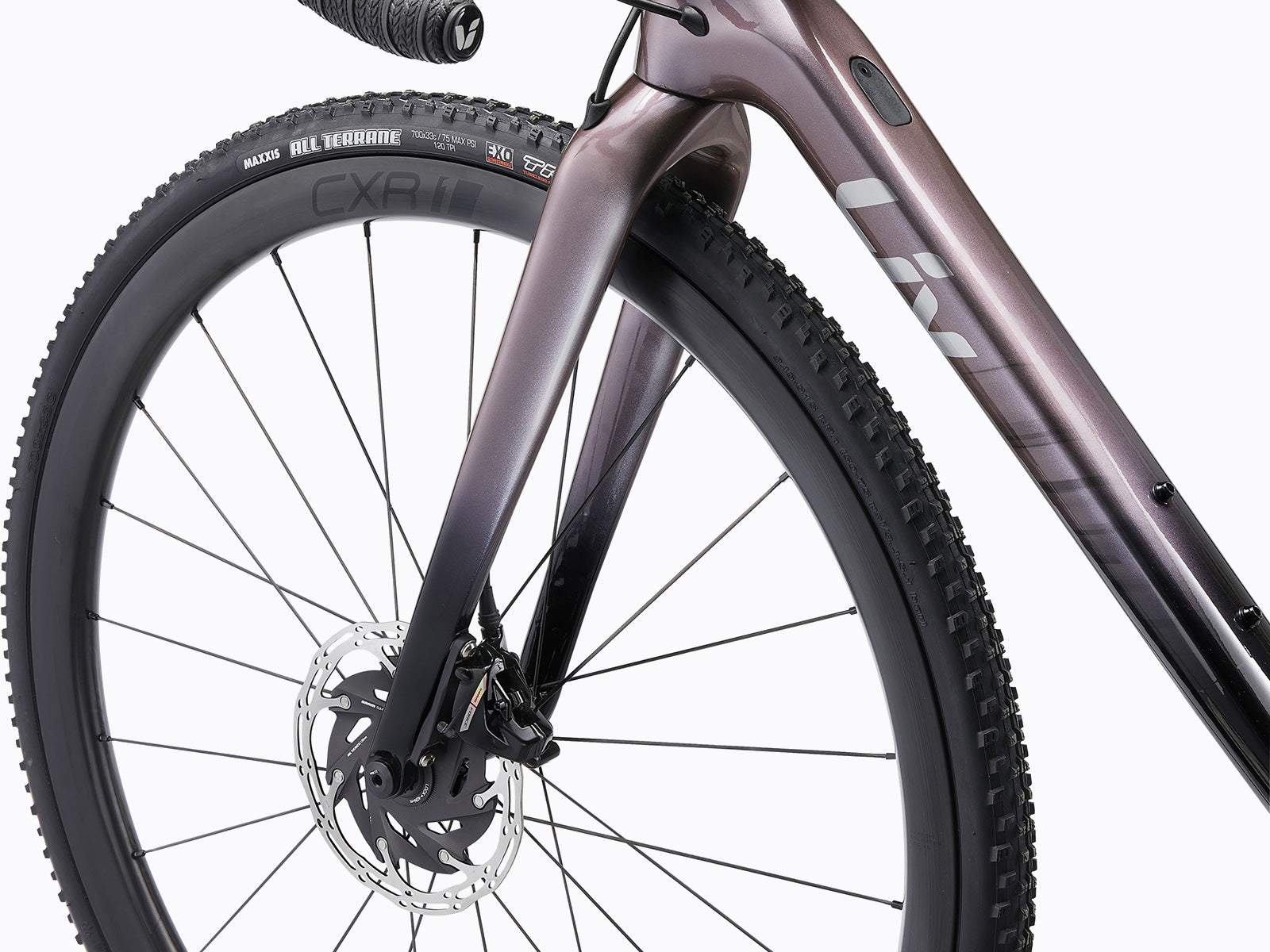 Close-up image of a bicycle's front wheel, featuring intricate details of the tire and spokes.
