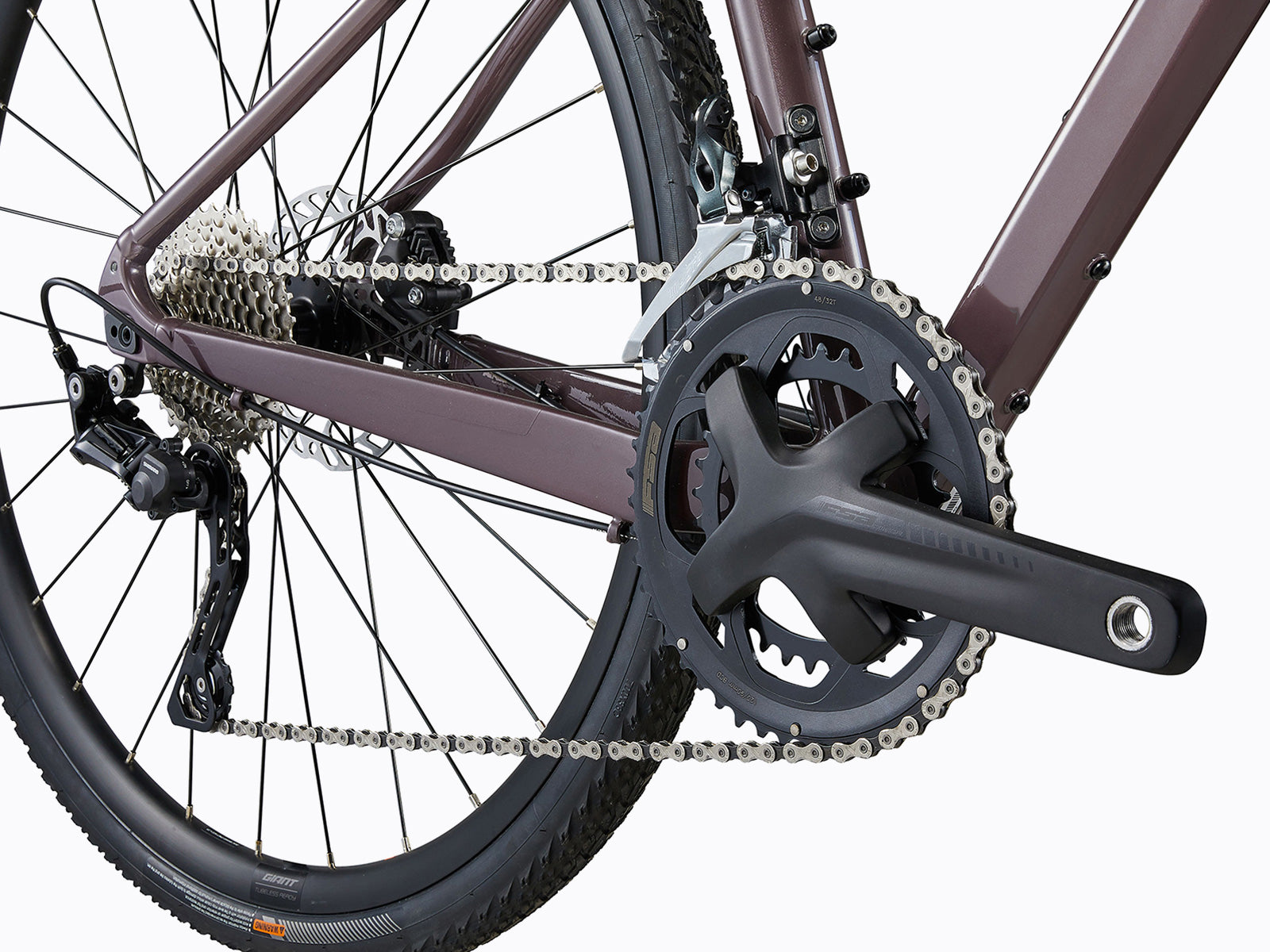 Close-up of a bicycle's chain and chainring, showcasing the intricate details of the components and their connection.