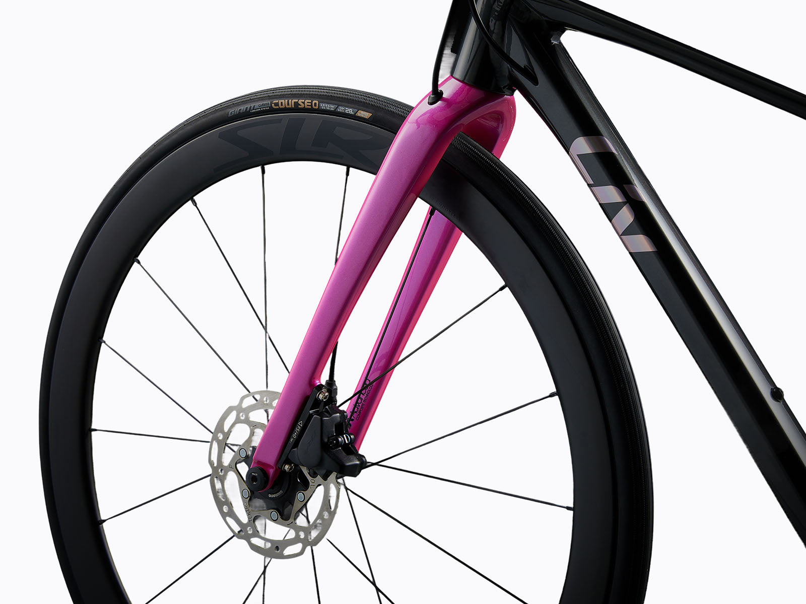 side view of a black road bike with pink fork.